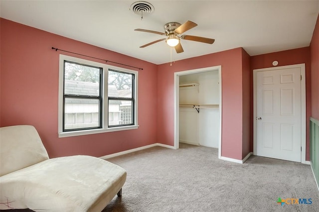 living area featuring visible vents, baseboards, a ceiling fan, and light colored carpet