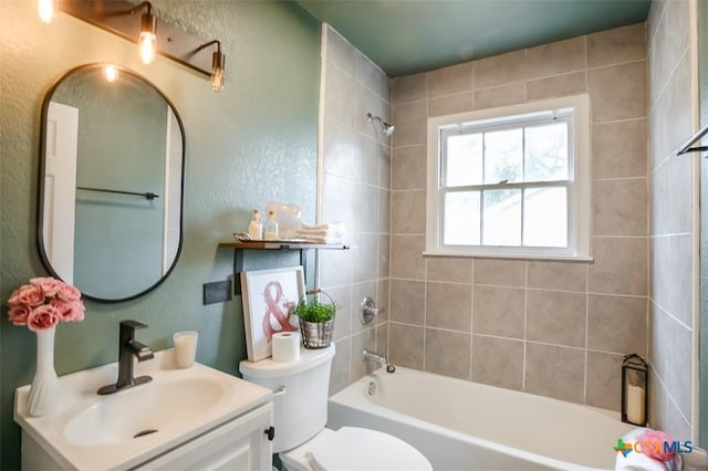 full bathroom featuring  shower combination, a textured wall, toilet, and vanity