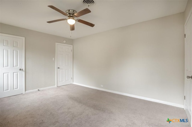 unfurnished bedroom with ceiling fan, carpet floors, visible vents, and baseboards