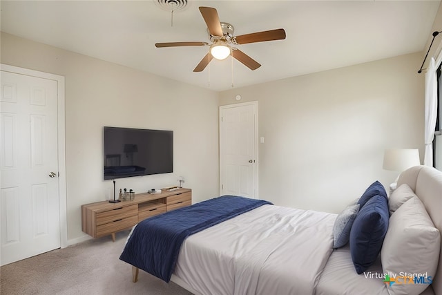 bedroom featuring light carpet, visible vents, and a ceiling fan