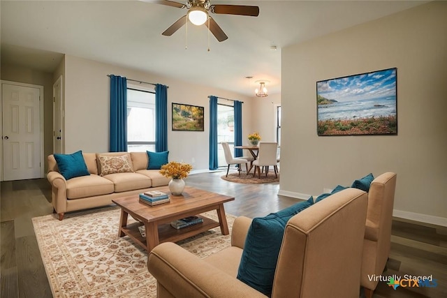 living area featuring ceiling fan, wood finished floors, and baseboards