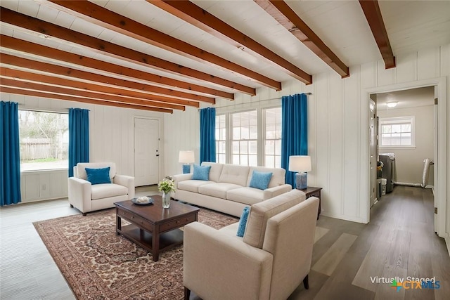 living room featuring beamed ceiling and wood finished floors