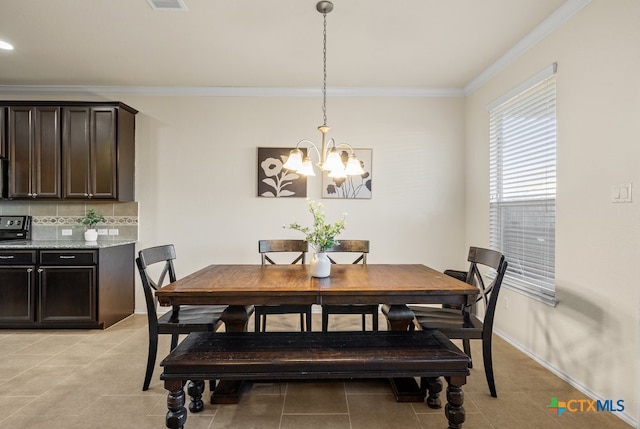 tiled dining room featuring ornamental molding and a chandelier