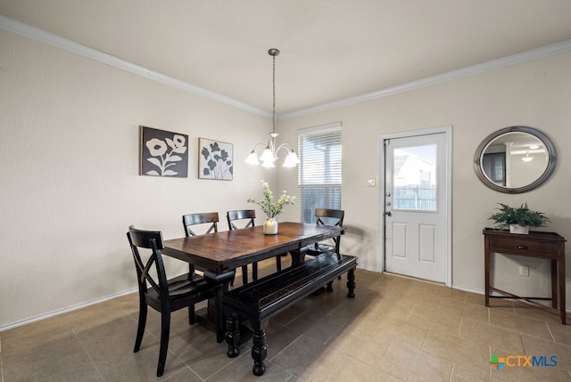 dining area with a chandelier and crown molding