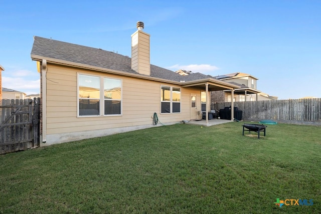 back of property featuring a lawn and a patio area