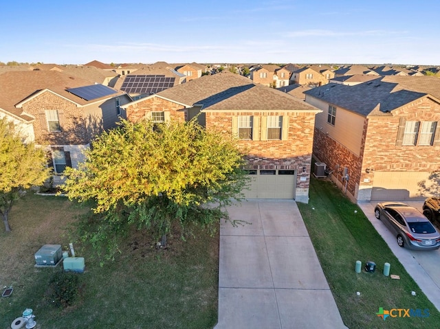 view of front of property featuring a garage and cooling unit