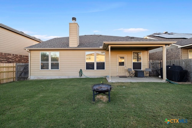 back of property featuring a patio and a yard