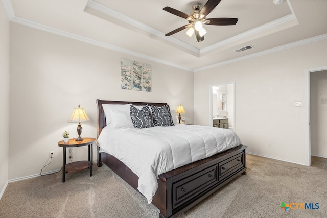 carpeted bedroom featuring ceiling fan, connected bathroom, a raised ceiling, and ornamental molding