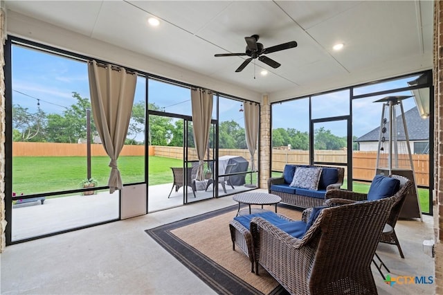 sunroom / solarium featuring ceiling fan