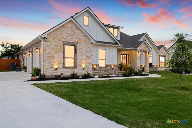 view of front of home with a yard and a garage