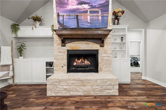 unfurnished living room with dark hardwood / wood-style flooring, a stone fireplace, and vaulted ceiling