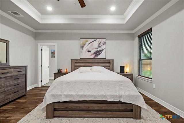 bedroom with ceiling fan, a tray ceiling, and crown molding