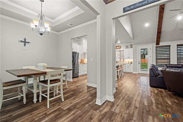 dining area featuring ornamental molding, dark hardwood / wood-style flooring, an inviting chandelier, and a raised ceiling