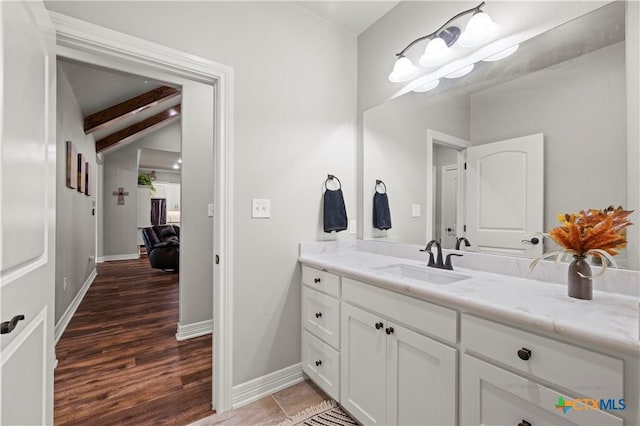 bathroom featuring vanity, tile patterned flooring, and vaulted ceiling with beams