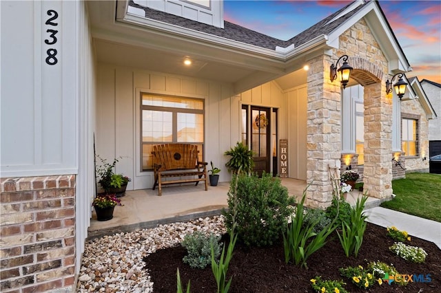 exterior entry at dusk with a porch