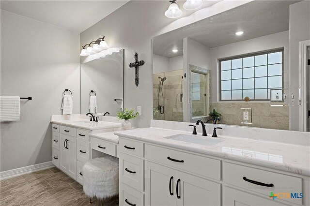 bathroom featuring walk in shower and vanity