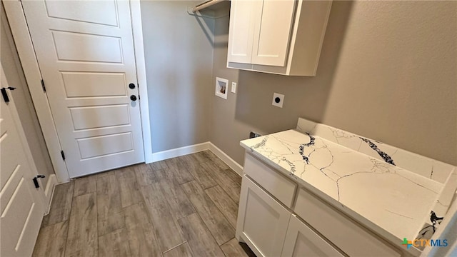 clothes washing area with light hardwood / wood-style floors, electric dryer hookup, cabinets, and washer hookup