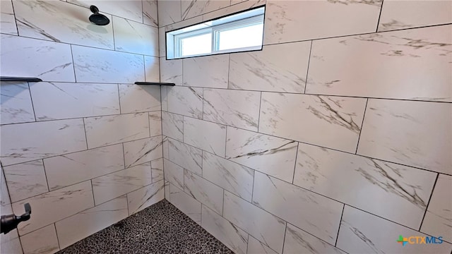 bathroom featuring tiled shower
