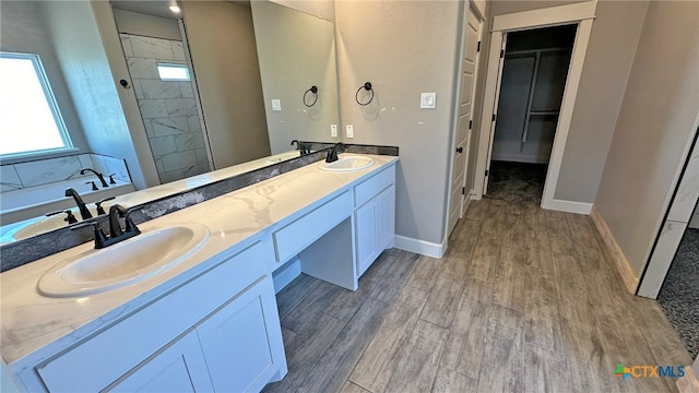 bathroom featuring independent shower and bath, vanity, and wood-type flooring