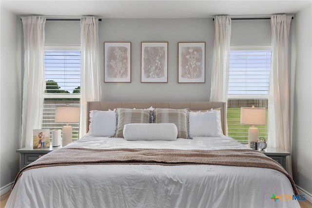bedroom featuring baseboards and wood finished floors