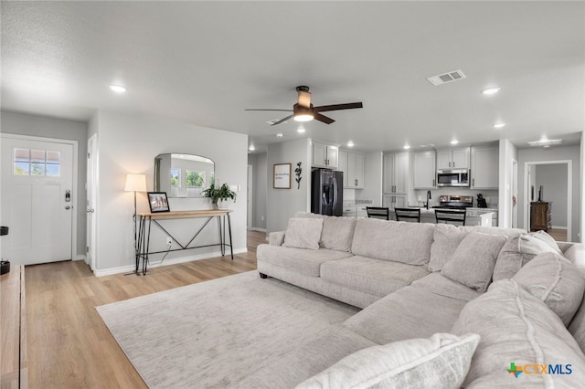 living area with recessed lighting, baseboards, and a wealth of natural light