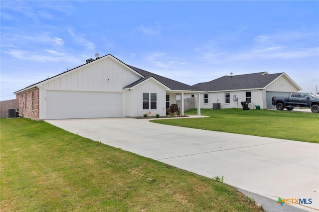 ranch-style house featuring a front lawn, a garage, board and batten siding, central air condition unit, and driveway