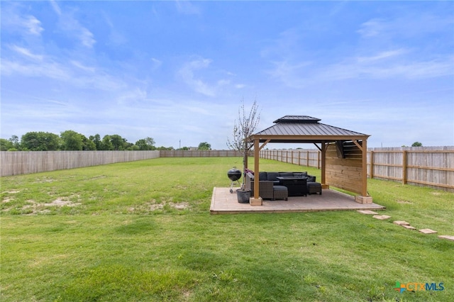 view of yard featuring a gazebo, outdoor lounge area, a fenced backyard, and a patio area