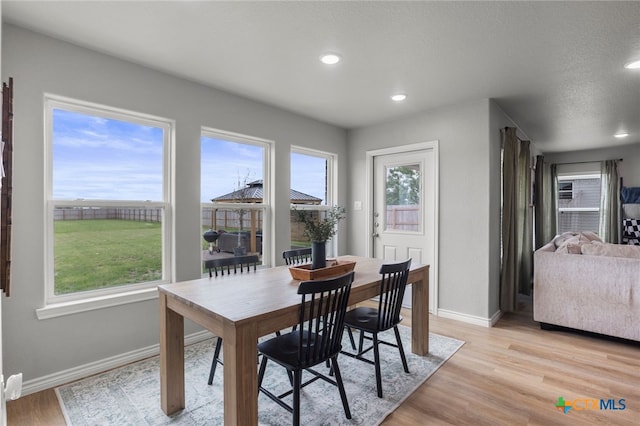 dining area with baseboards, recessed lighting, and light wood-style floors