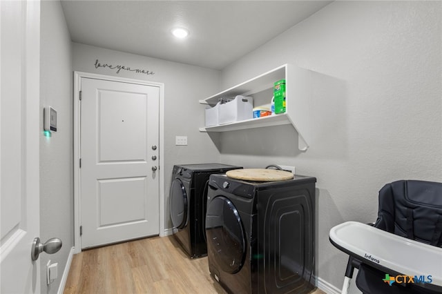laundry area featuring laundry area, light wood-style floors, baseboards, and washer and dryer