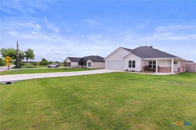 view of front of home with an attached garage, board and batten siding, concrete driveway, and a front lawn