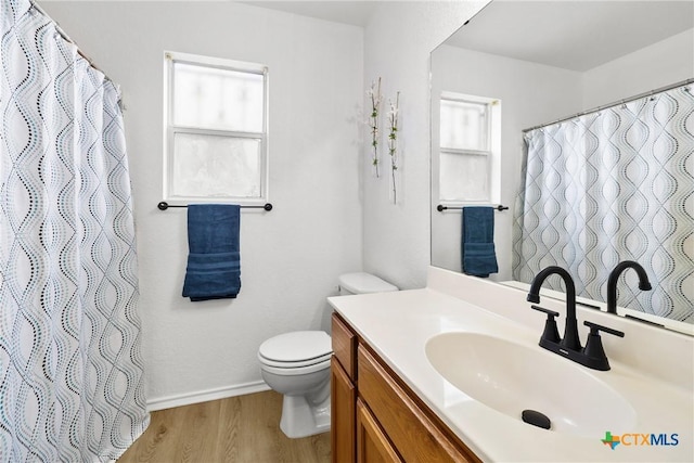full bath featuring vanity, toilet, baseboards, wood finished floors, and a shower with shower curtain