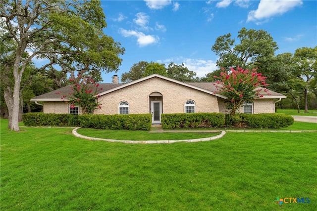 ranch-style home with a front lawn