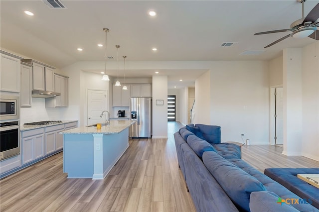 10259 Juniper Oaks, Boerne, TX 78006 - kitchen featuring stainless steel appliances, open floor plan, light wood finished floors, ceiling fan, and under cabinet range hood