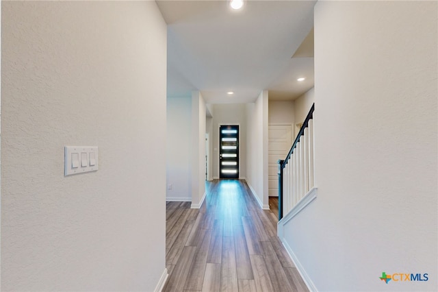 10259 Juniper Oaks, Boerne, TX 78006 - hall featuring wood finished floors, recessed lighting, a textured wall, and stairway