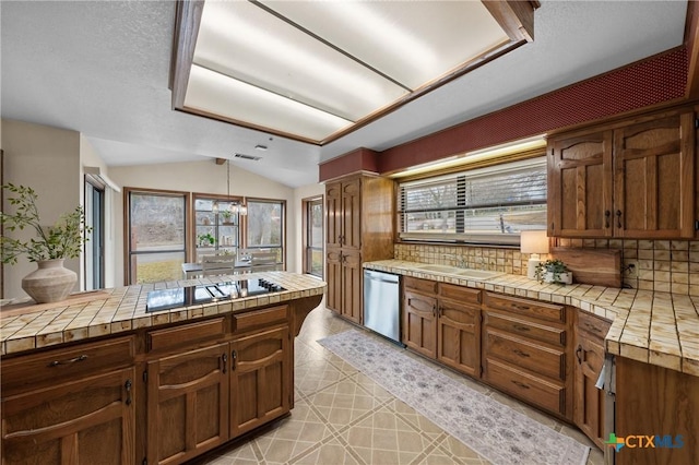 kitchen with tile countertops, lofted ceiling, black electric stovetop, decorative backsplash, and dishwasher