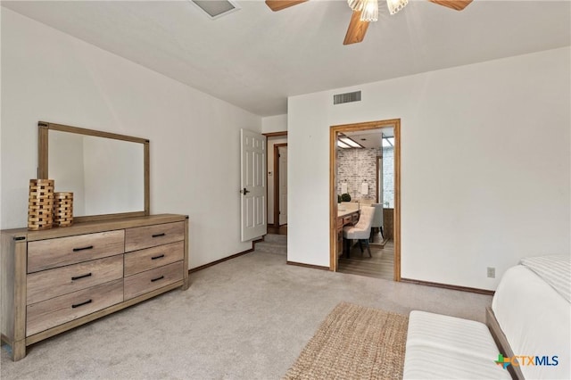 bedroom featuring light carpet, ceiling fan, visible vents, and baseboards