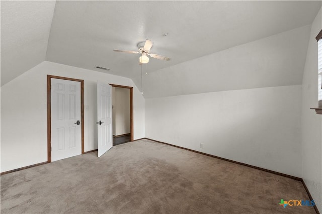 bonus room featuring vaulted ceiling, carpet flooring, visible vents, and a ceiling fan