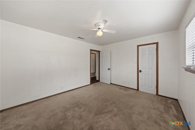 unfurnished bedroom with a ceiling fan, baseboards, visible vents, and carpet flooring