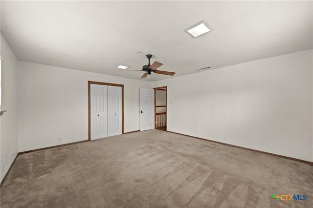 unfurnished bedroom featuring a ceiling fan, baseboards, visible vents, and carpet flooring