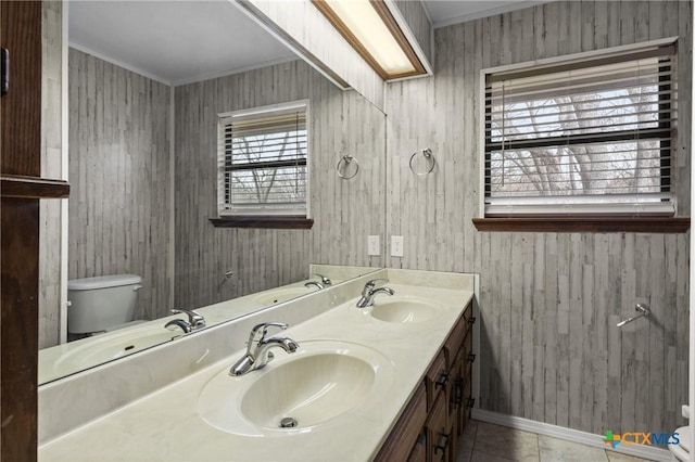 full bath featuring double vanity, a sink, and toilet