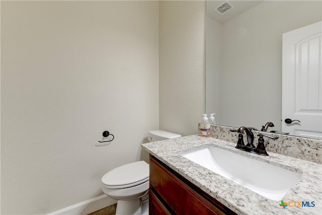 1040 Vista Dr, Salado, TX 76571 - bathroom featuring toilet, vanity, visible vents, and baseboards