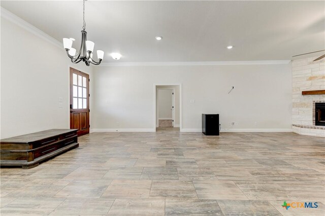1040 Vista Dr, Salado, TX 76571 - unfurnished living room with a notable chandelier, a fireplace, baseboards, ornamental molding, and recessed lighting