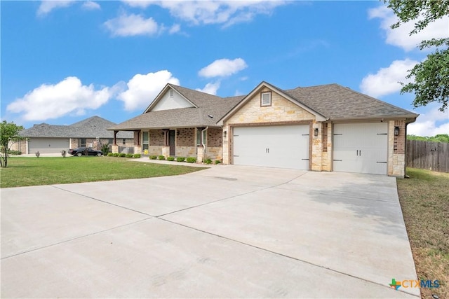1040 Vista Dr, Salado, TX 76571 - view of front of home with concrete driveway, fence, a garage, a shingled roof, and a front yard