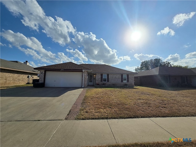 ranch-style home with a front lawn and a garage