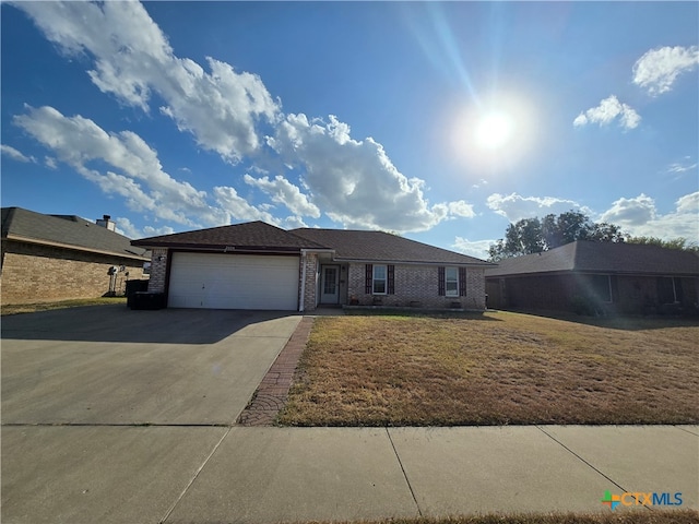 single story home featuring a garage and a front yard