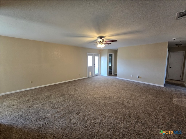 carpeted spare room with a textured ceiling and ceiling fan