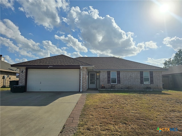 ranch-style home featuring a garage and a front lawn