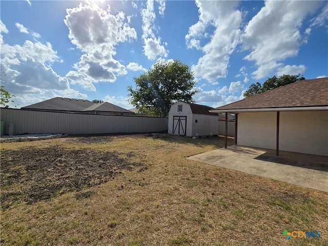 view of yard featuring a patio area and a shed