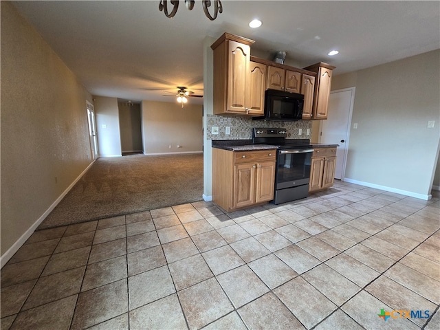 kitchen featuring black appliances, decorative backsplash, light tile patterned floors, and ceiling fan