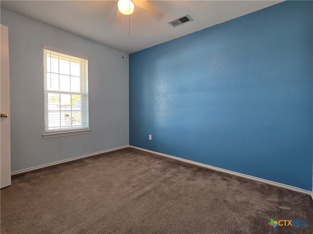 carpeted spare room featuring ceiling fan